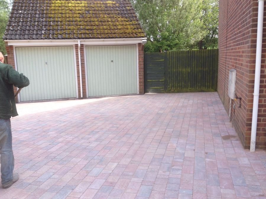 Block paved driveway in front of a garage